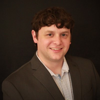 headshot of AtlasIED Director of DSP/Amp Engineering Tom Lureman smiling